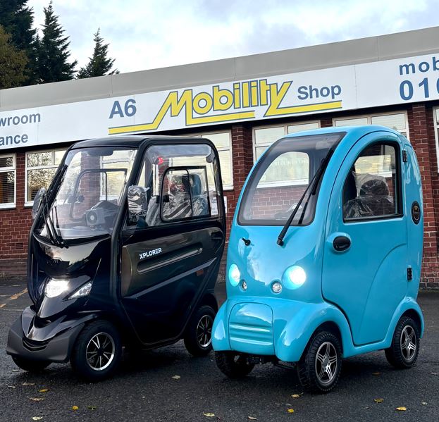 Blue and black cabin mobility scooters outside A6 Mobility Shop