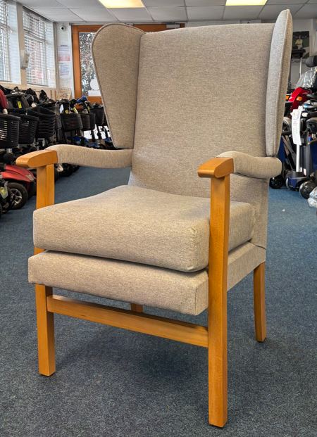 grey wooden high wing back chair inside A6 Mobility Shop