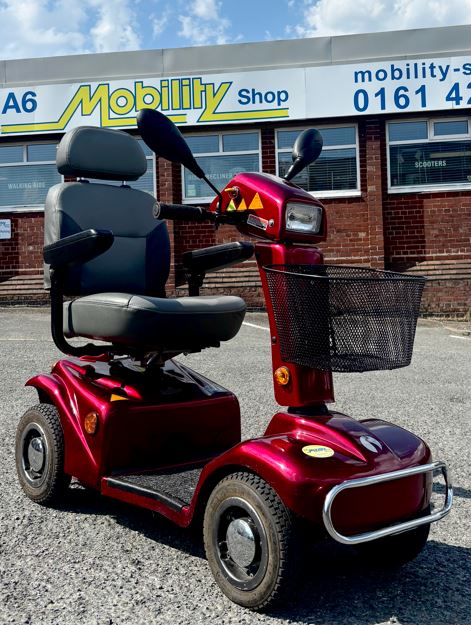 Red mobility scooter pictured outside A6 Mobility Shop in Stockport, Greater Manchester
